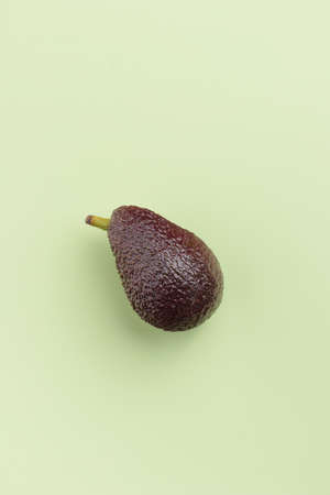 Avocado fruit on a green background top viewの写真素材