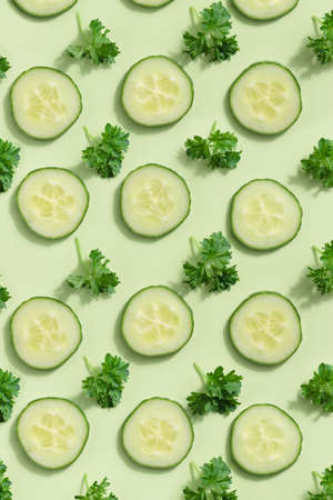 Cucumber slices pattern on a green backgroundの写真素材