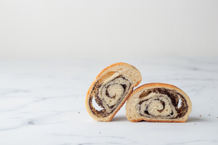 Homemade poppy seed roll buns on a white table