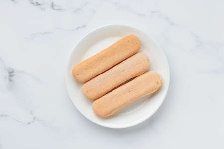 Italian cookie savoiardi. Sweet biscuits. Sponge cookies tiramisu isolated on white background. copy...