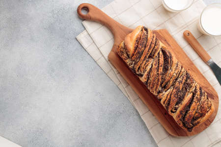 Sweet swirl homemade bread with poppy seeds on a gray concrete backgroundの写真素材