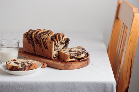 Sweet swirl homemade bread with poppy seeds on a white table
