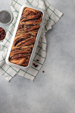 Sweet swirl homemade bread with poppy seeds on a gray concrete backgroundの写真素材