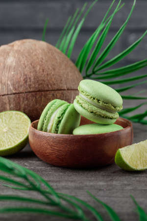 Green macaroons on a gray concrete background. Verticalの写真素材
