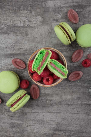 Green macaroons on a gray concrete background. Verticalの写真素材