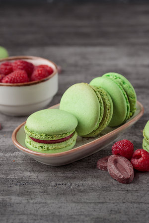 Green macaroons on a gray concrete background. Verticalの写真素材