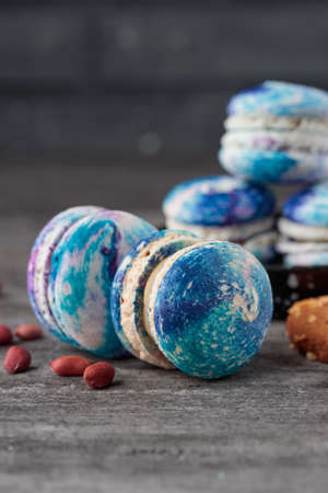Blue macaroons on a gray concrete background. Vertical