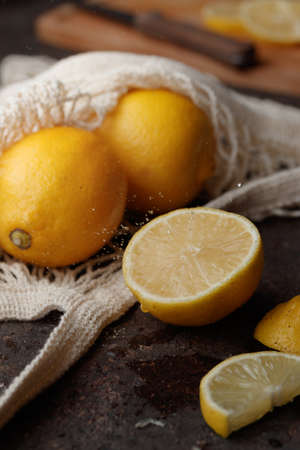 Fresh juicy lemon slices on a dark background verticalの写真素材