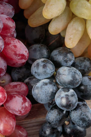 Grapes in a wooden box on a dark backgroundの写真素材