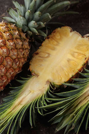 Ripe pineapple on the dark table