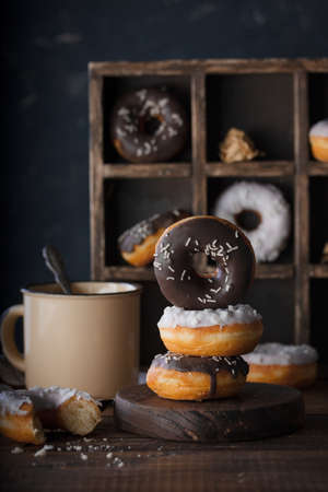 Donuts with dark and white chocolate on a dark backgroundの写真素材