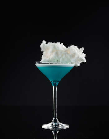 Cocktail in a glass on a black background verticalの写真素材