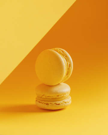 Lemon macaroons on a yellow background verticalの写真素材