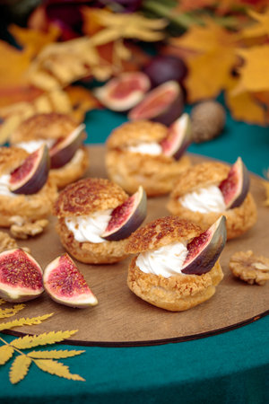 Autumn sweet dessert decorated on a table in the parkの写真素材