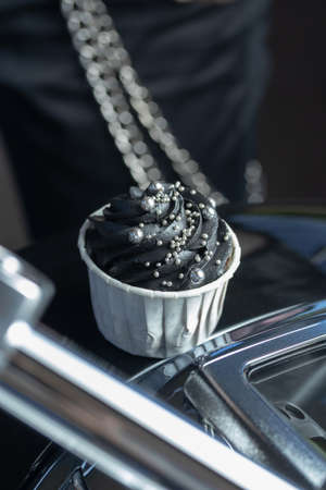 Grunge style cupcakes with black and pink cream vertical