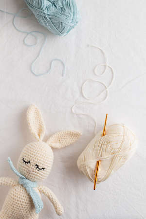 Cute handmade crochet knitted amigurumi bunny with a blue scarf