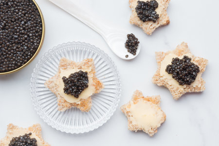 Black caviar appetizers bread star on a white background top view with a pearl spoon Horizontalの写真素材