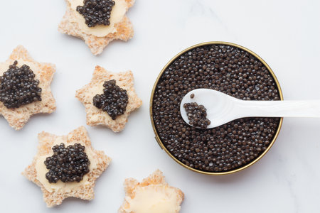 Black caviar appetizers bread star on a white background top view with a pearl spoon Horizontalの写真素材