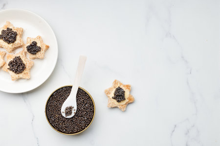 Black caviar appetizers bread star on a white background top view with a copy space Horizontal bannerの写真素材