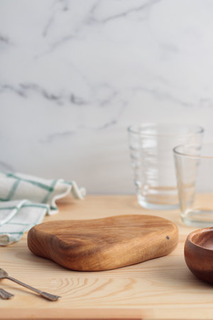 Empty tableware - wooden cutting board , a bowl on wooden table as a background for a dish foodbackgroundvertical photoの写真素材