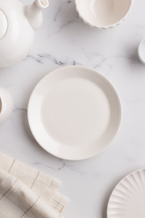 Empty tableware - white plate a bowl and a cup on white table as a background for a dish...