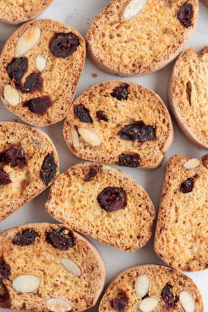 Biscotti cantucci cookies with almond and cranberry on white background vertical photoの写真素材