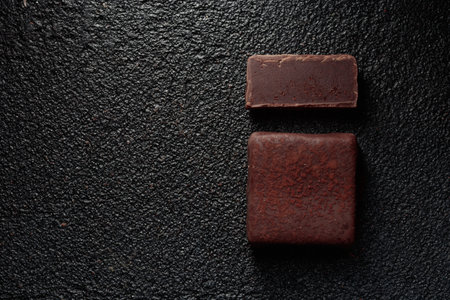 Chocolate handcrafted bonbons and cuttse piece of candy with truffle on a black background with copyspace horizontal banner top viewの写真素材