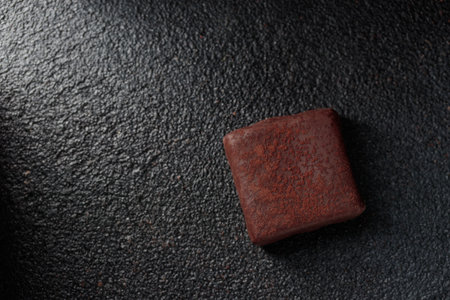 Chocolate handcrafted bonbon candy with truffle on a black background with copyspace horizontal banner top viewの写真素材