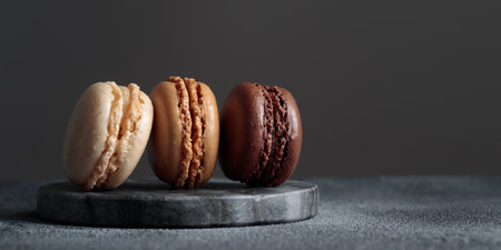 Chocolate eco handmade natural macaroons on dark background in the darkmood style. Horizontal banner top view with a copyspaceの写真素材