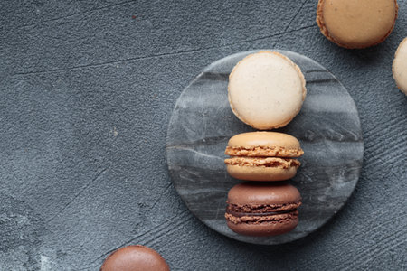 Colorful pastel eco handmade natural macaroons on dark marble background. Gift for 8 March, International Women's Day, Valentine's Day. Horizontal banner top view with a copyspaceの写真素材