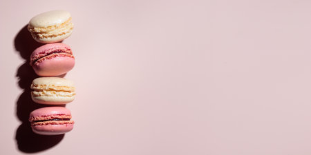Macaroons on pink background, colorful french cookies pattern. Gift for 8 March, International Women's Day, Valentine's Day. Horizontal banner with copyspaceの写真素材