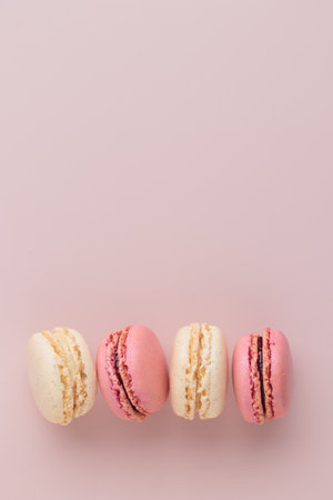 Macaroons on pink background, colorful french cookies pattern. Gift for 8 March, International Women's Day, Valentine's Day. Vertical banner with copyspaceの写真素材