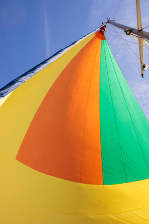 Colorful gennaker sail of a sailing yacht in the wind, sailing on the sea, calm sunny weather, gulf...
