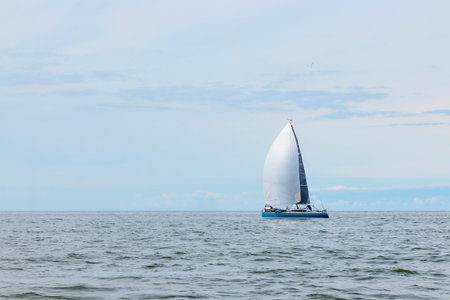 Yacht sailing at waves of the open sea. Nautical landscape with sailboat - cruising yacht sailing...
