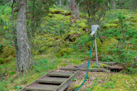 Very Old Antique vintage Hand Manual station water pump for water supply. Old metal plumbing watering in the countryside in the forest of Finland.の写真素材