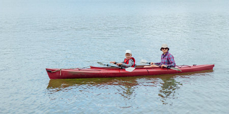 Father and son together, family activity by kayaking in the, canoeing, boating in the Baltic sea...