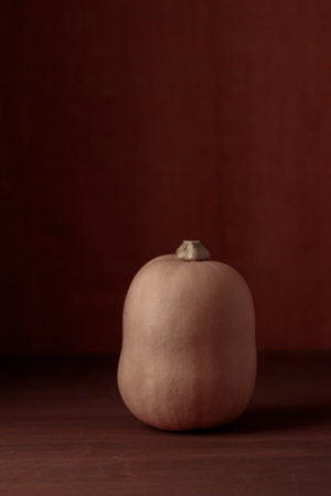Pumpkin on a wooden table, October decor with copy space