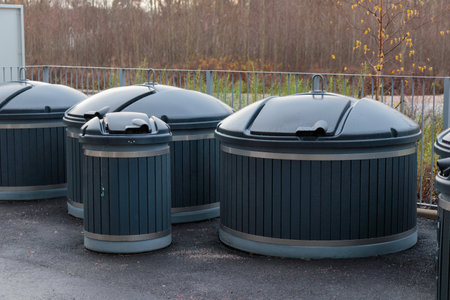 Plastic containers for separate waste collection. Bins for garbage separation outdoors on with lids. Trash like domestic refuse, rubbish, recycling and garden waste, Finlandの写真素材
