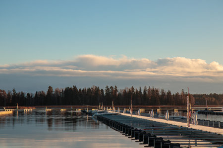 Sea marina in autumn, abandoned sailboats in a calm sea, empty pier in harbor, autumn, short sailing season in Finland, Suomenojaの写真素材