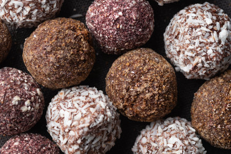 Assortment of gourmet handcrafted vegan chocolate truffle candies on dark background from premium confectionary. Handmade bonbon chocolatier concept. Horizontal banner top viewの写真素材