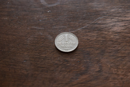 Old vintage German coin on wooden background with copy spaceの写真素材