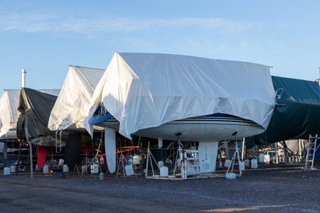 Sailboats are covered and stored out of the water for the winter, winter storage for the sailboat in Finland, Suomenoja, winterizing , short season in Northern country, cold conditionsの写真素材