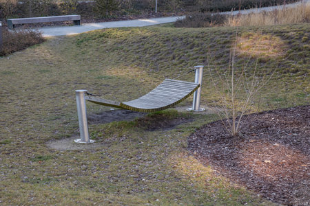 A free-standing hammock with a sturdy metal or wooden frame, set in a garden or patio. Ideal for outdoor relaxation, offering comfort without needing trees or attachmentsの写真素材