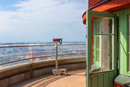 Observation deck of the red Hanko Water Tower in Finland on a sunny summer day. Equipped with a viewing binocular for visitors to enjoy scenic panoramic views of the city, harbor and coastlineの写真素材