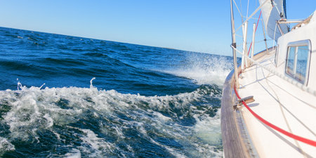 Luxury sailing yacht under genoa and mainsail cutting through waves of the Baltic Sea, Gulf of...
