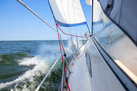 Luxury sailing yacht under genoa and mainsail cutting through waves of the Baltic Sea, Gulf of...