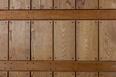 Wooden panels with small nails. Diagonal timber planks showing natural grain, patina, and texture, reflecting rustic Nordic craftsmanshipの写真素材