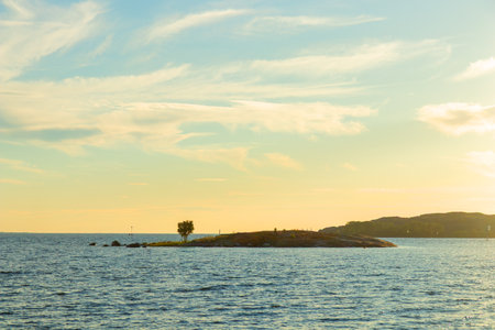 Scenic sunrise view of the Baltic Sea, concept of eco-tourism, travelling. Clean waters, natural coastline, and sustainable travel harmony with Finnish nature, marine environmentの写真素材