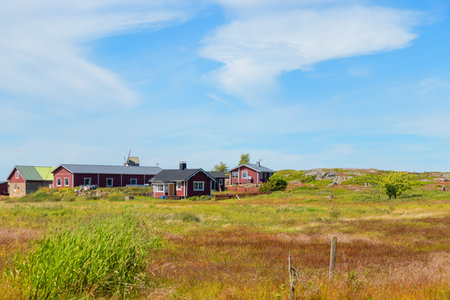 Scenic view of a Finnish fishing village. Traditional wooden houses, boathouses, piers, and peaceful coastal landscape in northern countrysideの写真素材