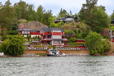 Charming Swedish houses along Stockholm fjord coast. Idyllic Nordic summer travel destination, perfect for vacation, relaxation, and exploring Scandinavian lifestyleの写真素材